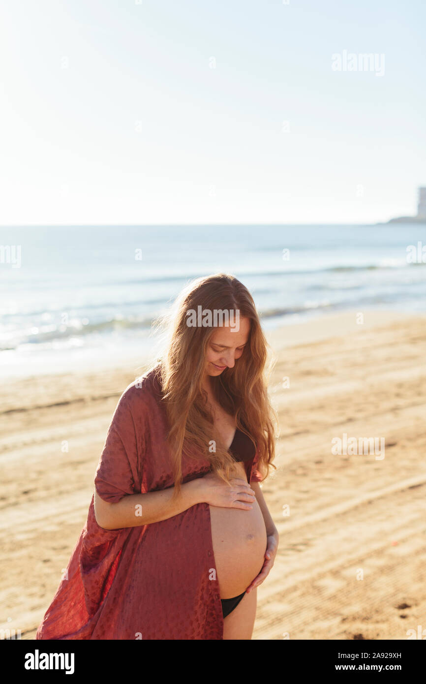 Pregnant woman on beach Stock Photo