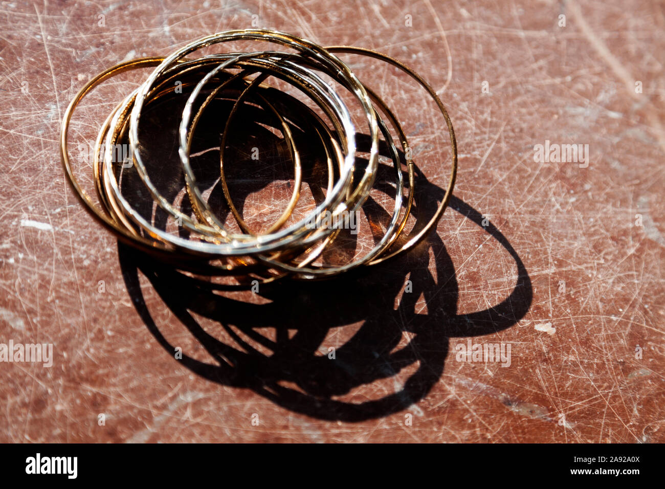 metal rings and jewelry on a marble table somewhere on Roback Stock