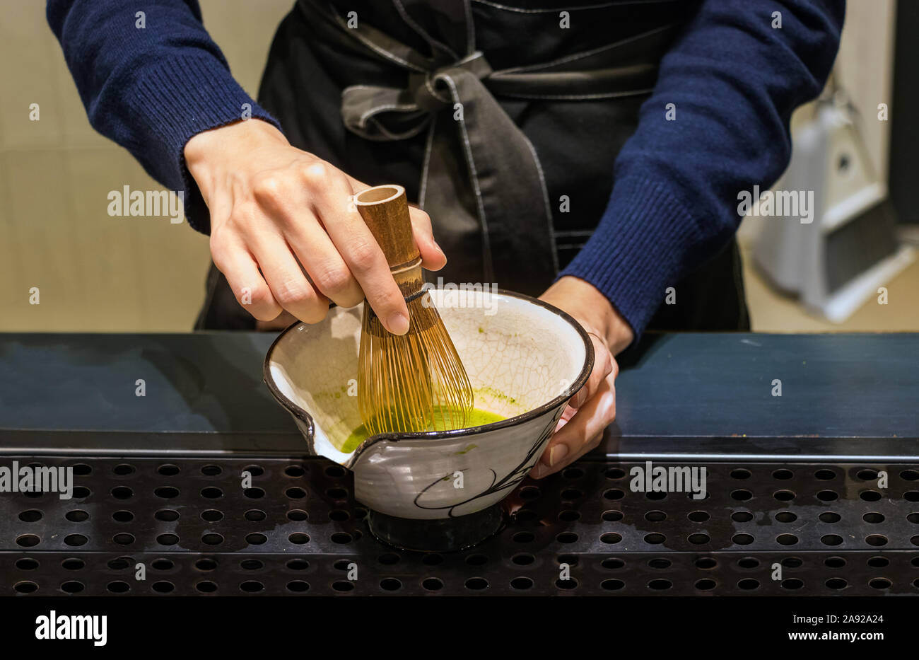 https://c8.alamy.com/comp/2A92A24/female-barista-hands-preparing-matcha-tea-on-a-bowl-mixing-it-with-a-bamboo-whisk-in-busan-korea-2A92A24.jpg