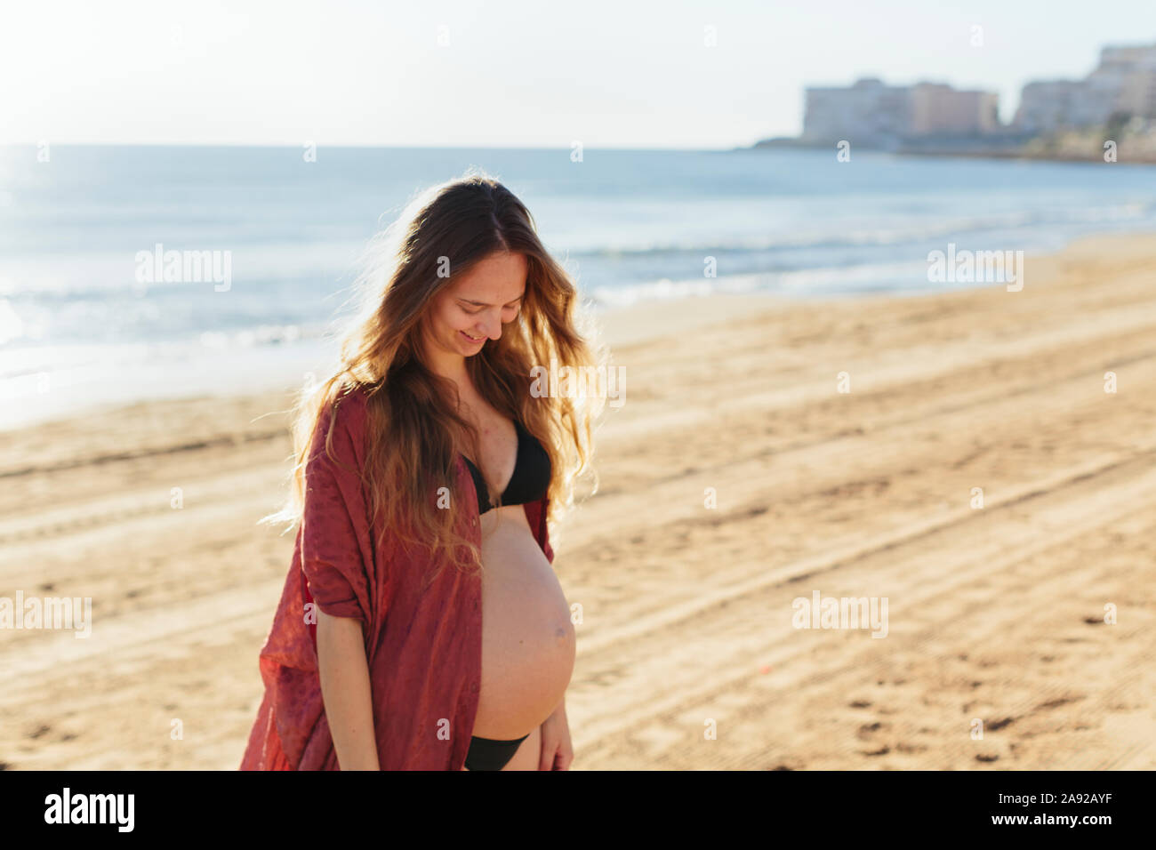 Pregnant woman on beach Stock Photo