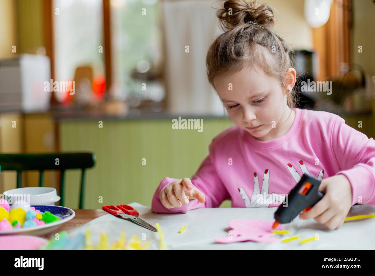 Girl with glue gun Stock Photo Alamy