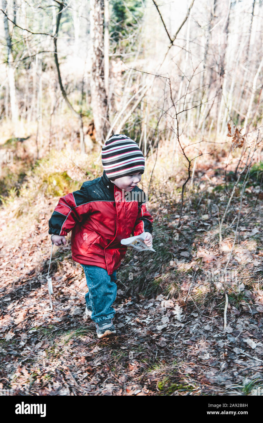 Boy walking in forest Stock Photo - Alamy