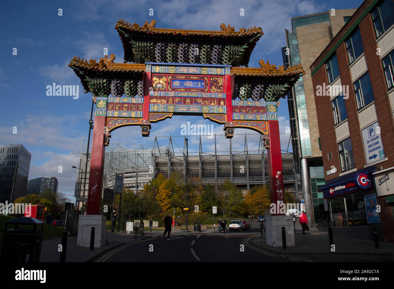 The Chinese arch, St Andrews Street, the northernmost end of Newcastle's Chinatown, with the football stadium, Newcastle upon Tyne England UK Stock Photo