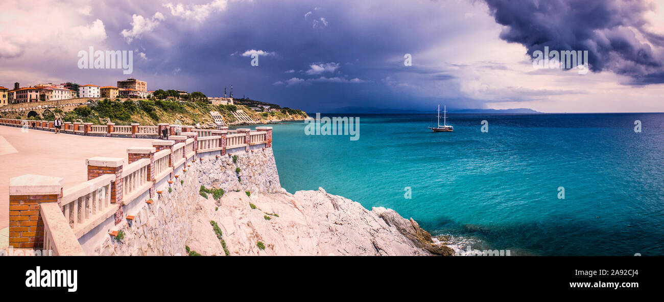 Cloudy Piombino (Tuscany) shore panorama with with view towards the mediterranean sea and thunder clouds rolling over Stock Photo