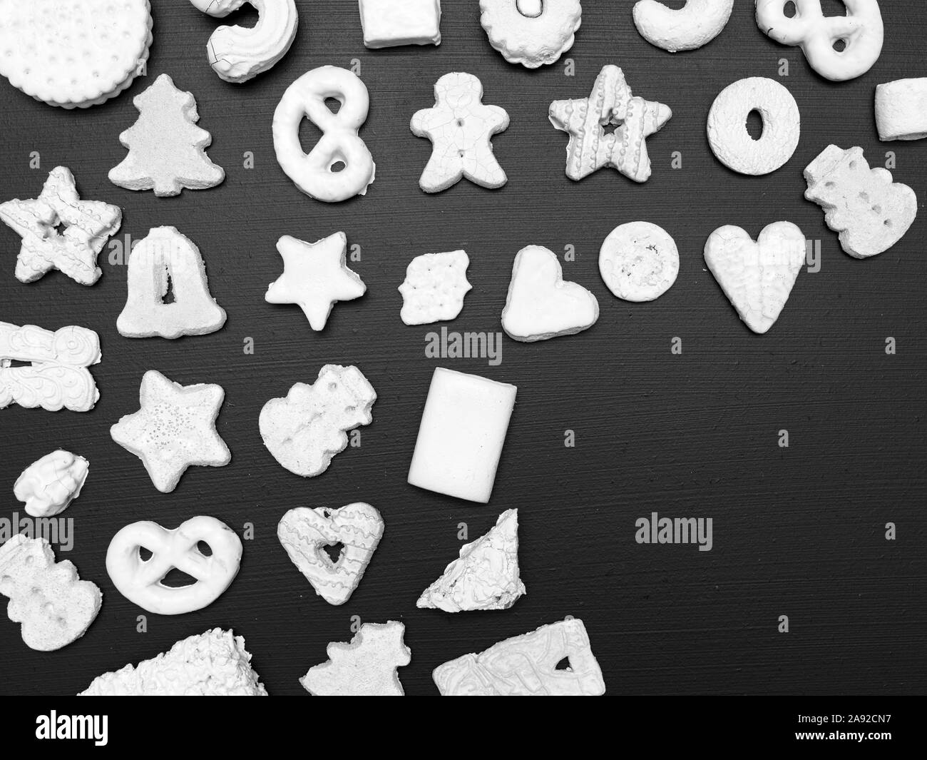 many different white christmas cookies on black background Stock Photo