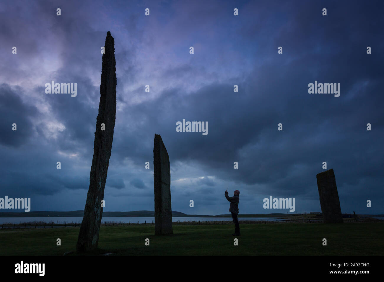 Orkney, Scotland, UK. 12th Nov, 2019. Ominous clouds drift over the neolithic Standing Stones of Stenness, Orkney Islands, Scotland Stock Photo