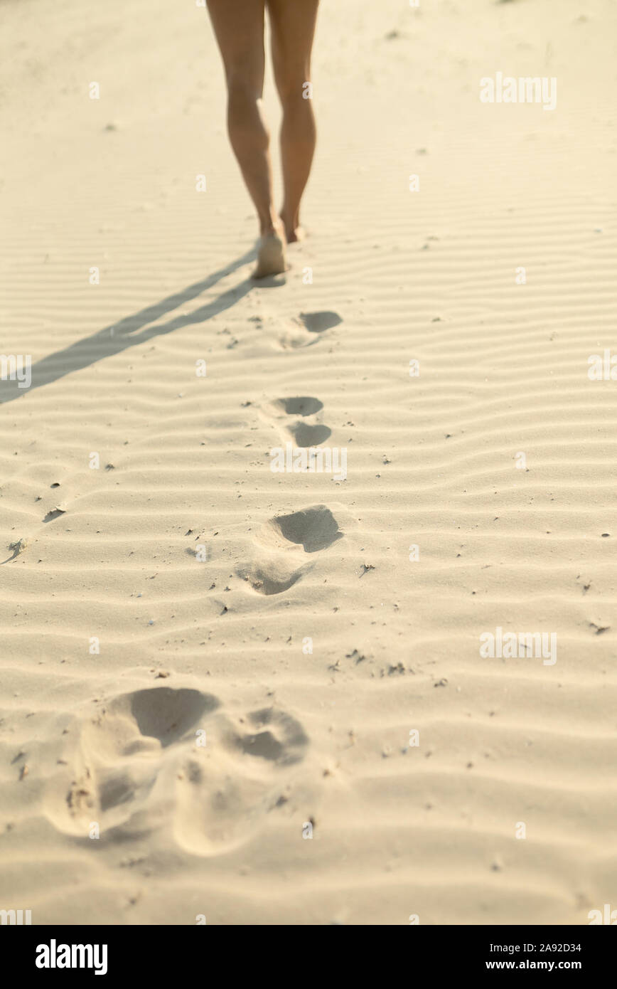 Woman walking on sand Stock Photo Alamy
