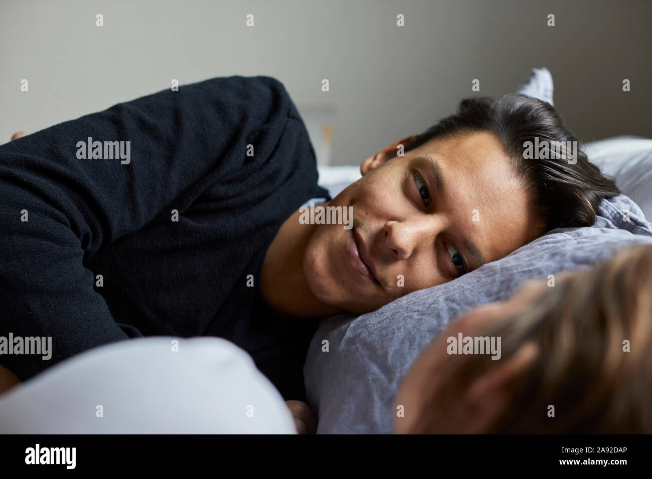 Man in bed Stock Photo - Alamy
