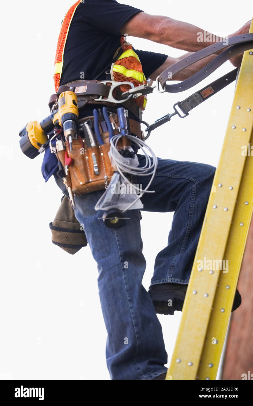 Lineman climbing a ladder Stock Photo Alamy