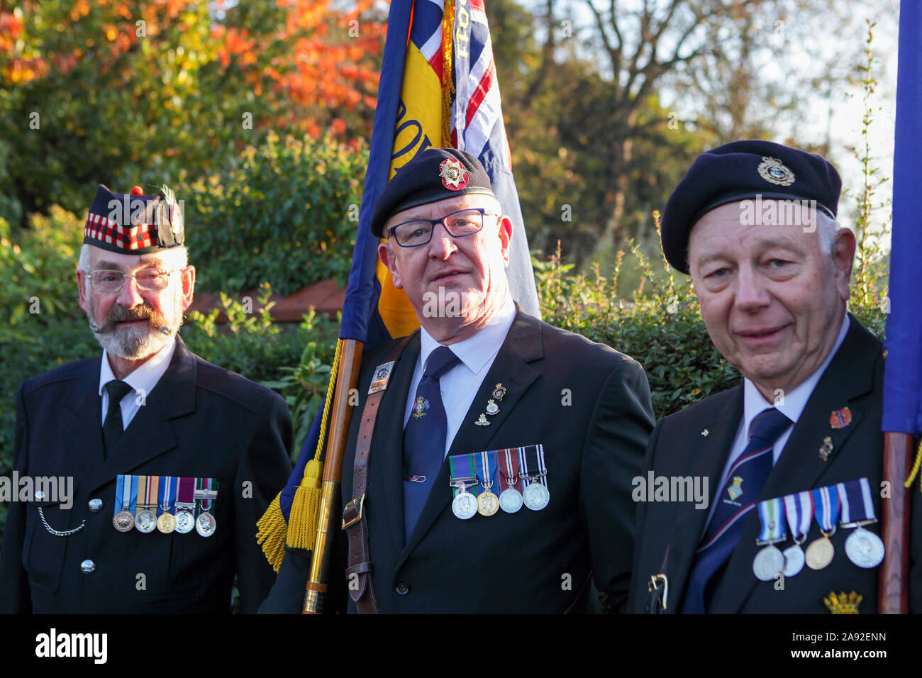 Remembrance Sunday commemorations on a beautiful Sunday at Shrewsbury Castle in Shropshire. Three retired soldiers pose for the camera. Stock Photo
