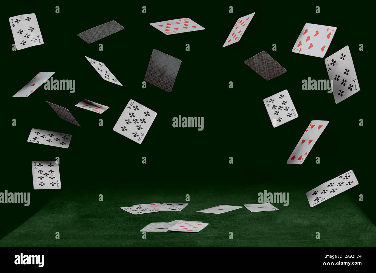 playing cards on green table on a dark background Stock Photo