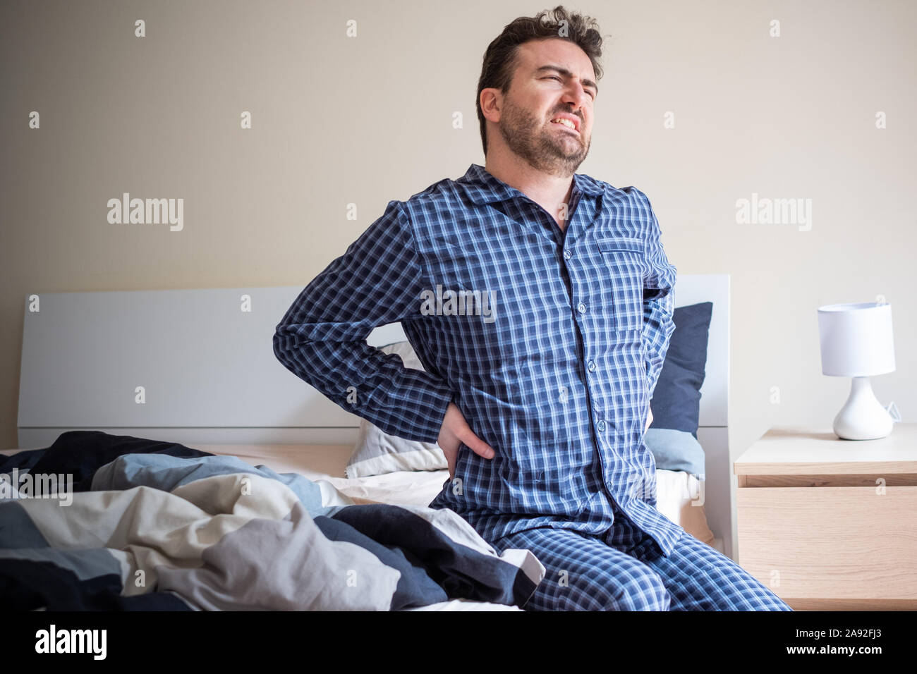 Man feeling backache after bed posture sleep Stock Photo Alamy