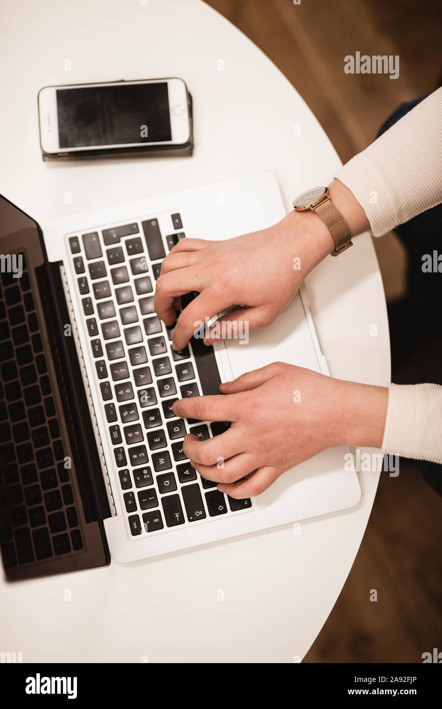 Hands typing on laptop keyboard Stock Photo