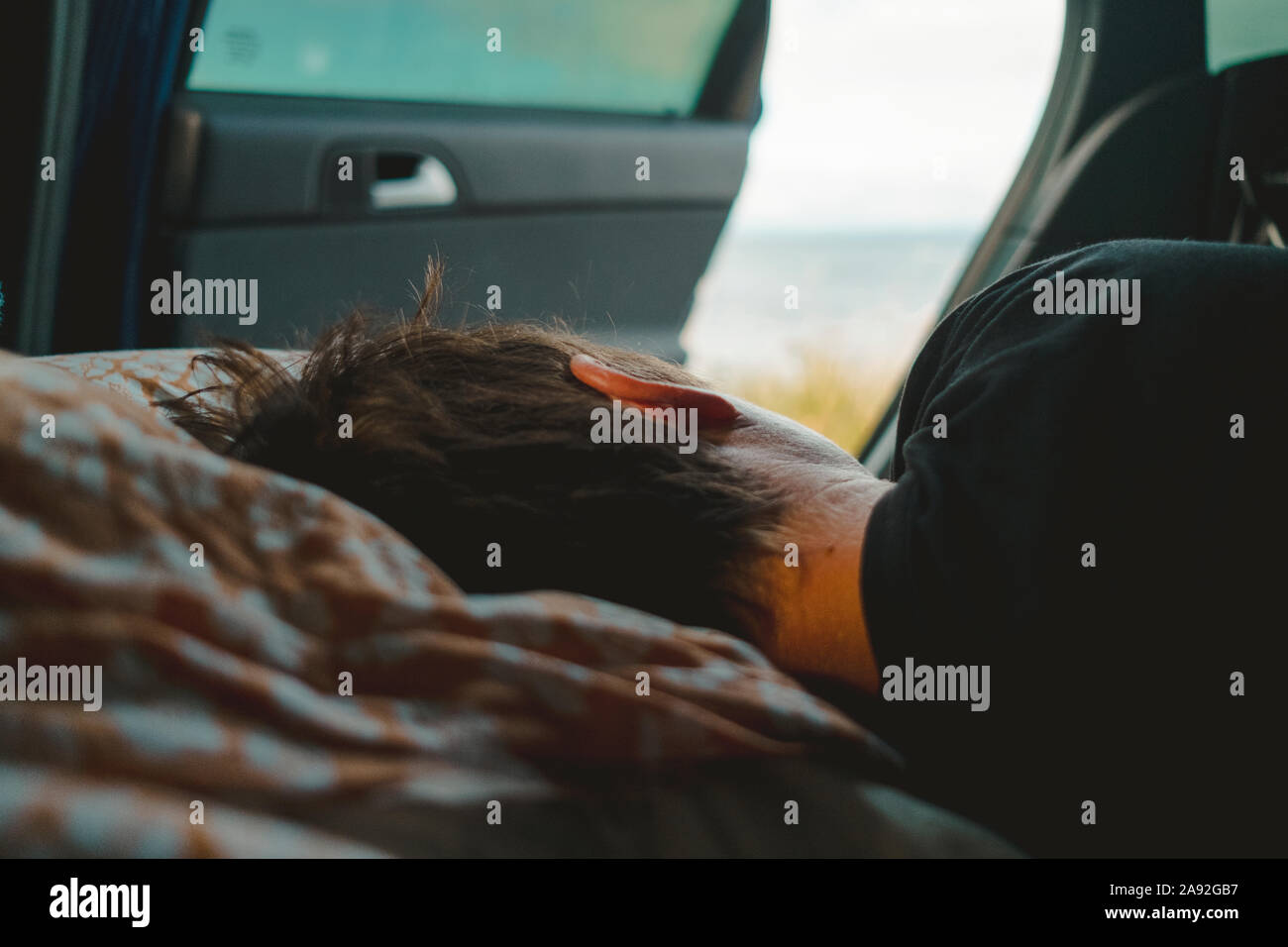 Person sleeping in car Stock Photo