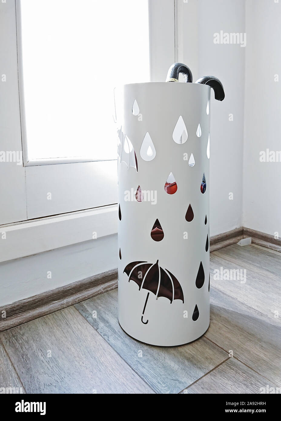 Modern lobby interior with umbrella container holder near entrance door