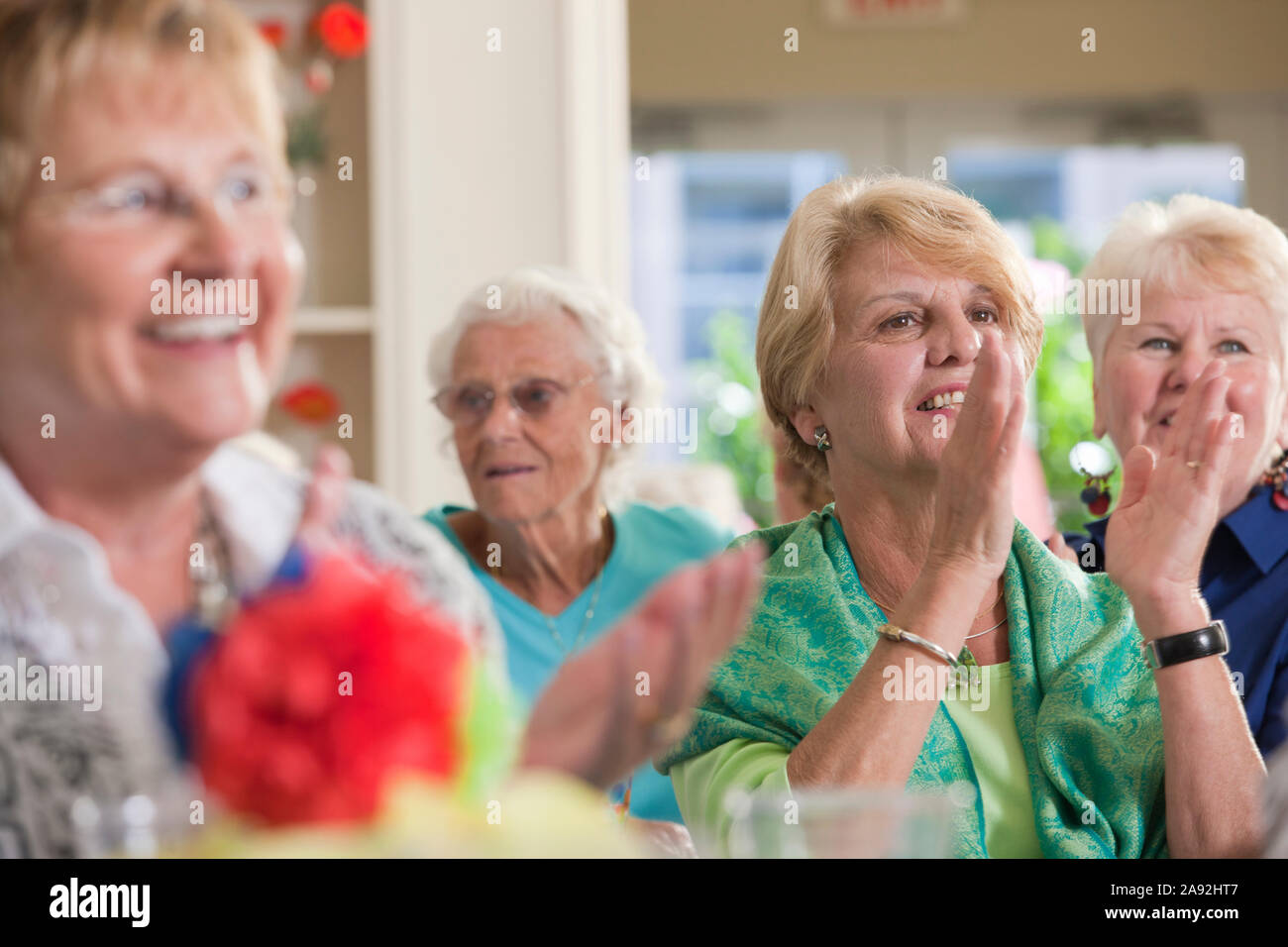 Senior women clapping at a luncheon Stock Photo Alamy