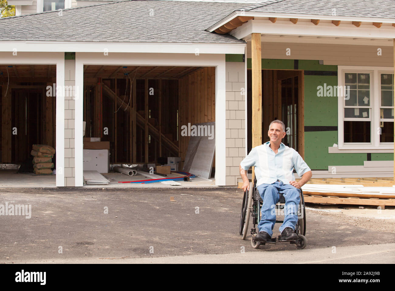 Man with spinal cord injury in a wheelchair at his new accessible home ...