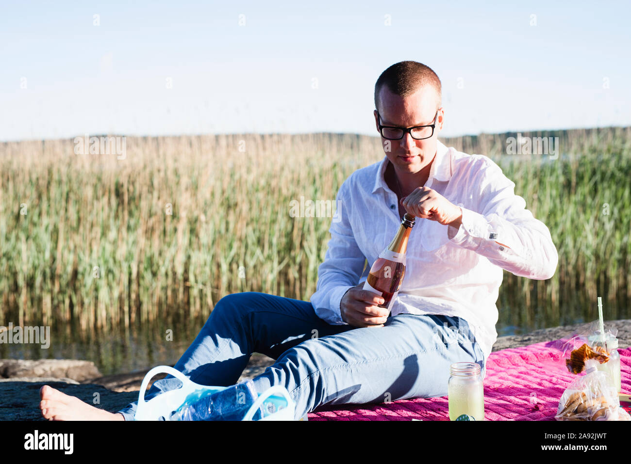 Man opening champagne Stock Photo