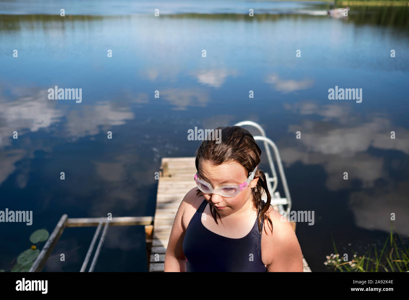 Girl on jetty Stock Photo