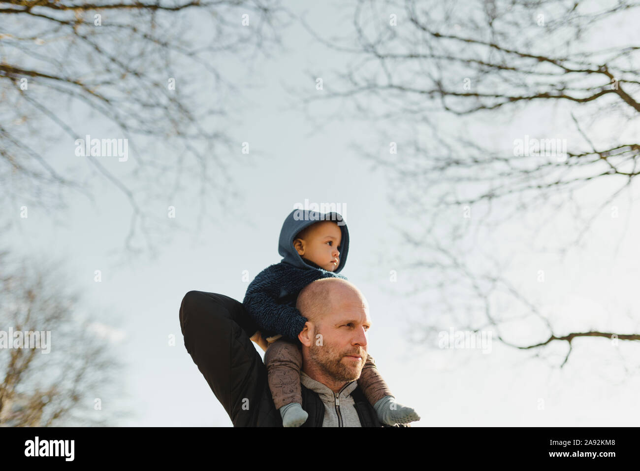 Father carrying boy on shoulders Stock Photo