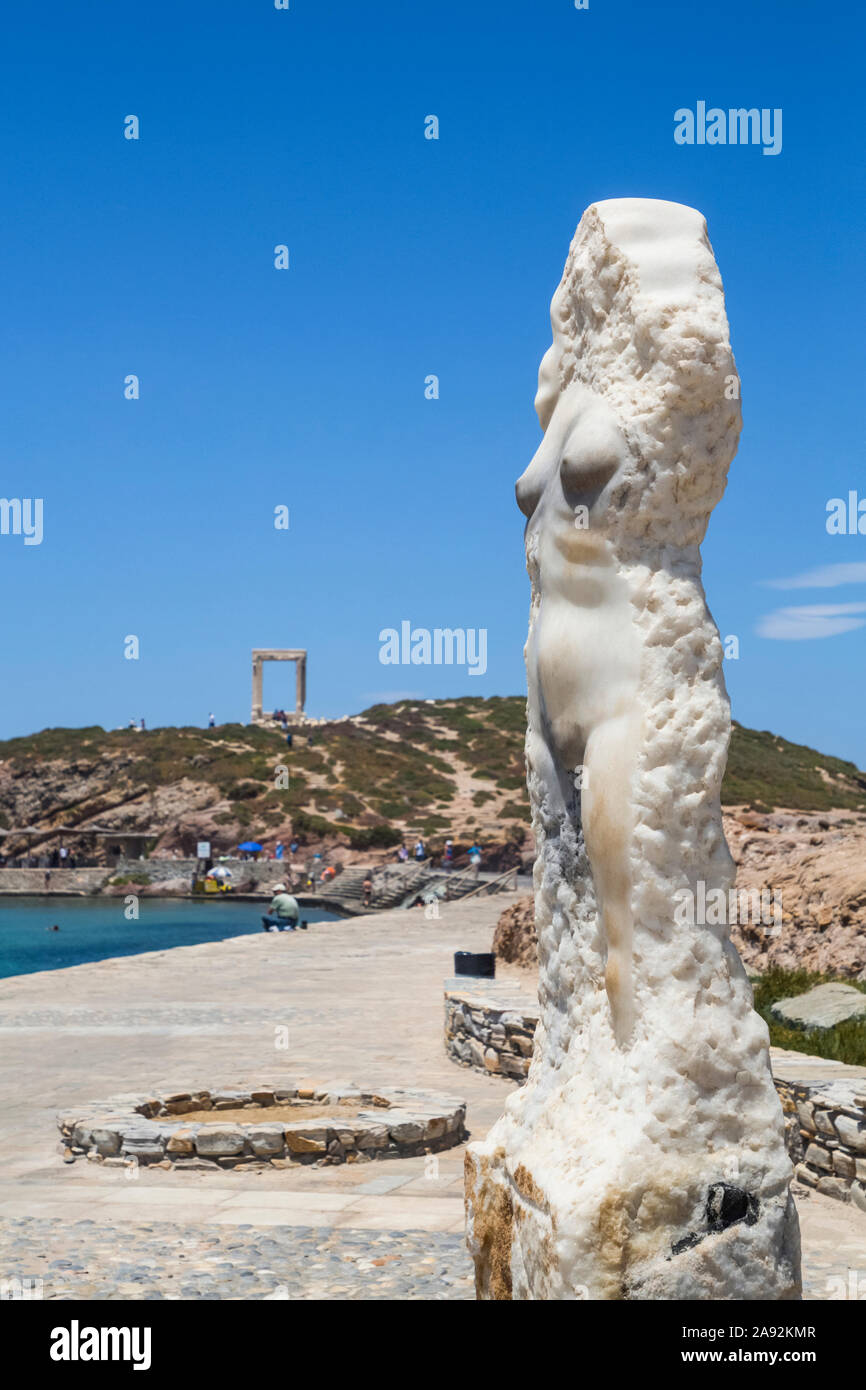 Tourists and swimmers enjoy a recreation area on the waterfront of the Mediterranean Sea with a recovered statue of a Greek goddess in the foreground Stock Photo