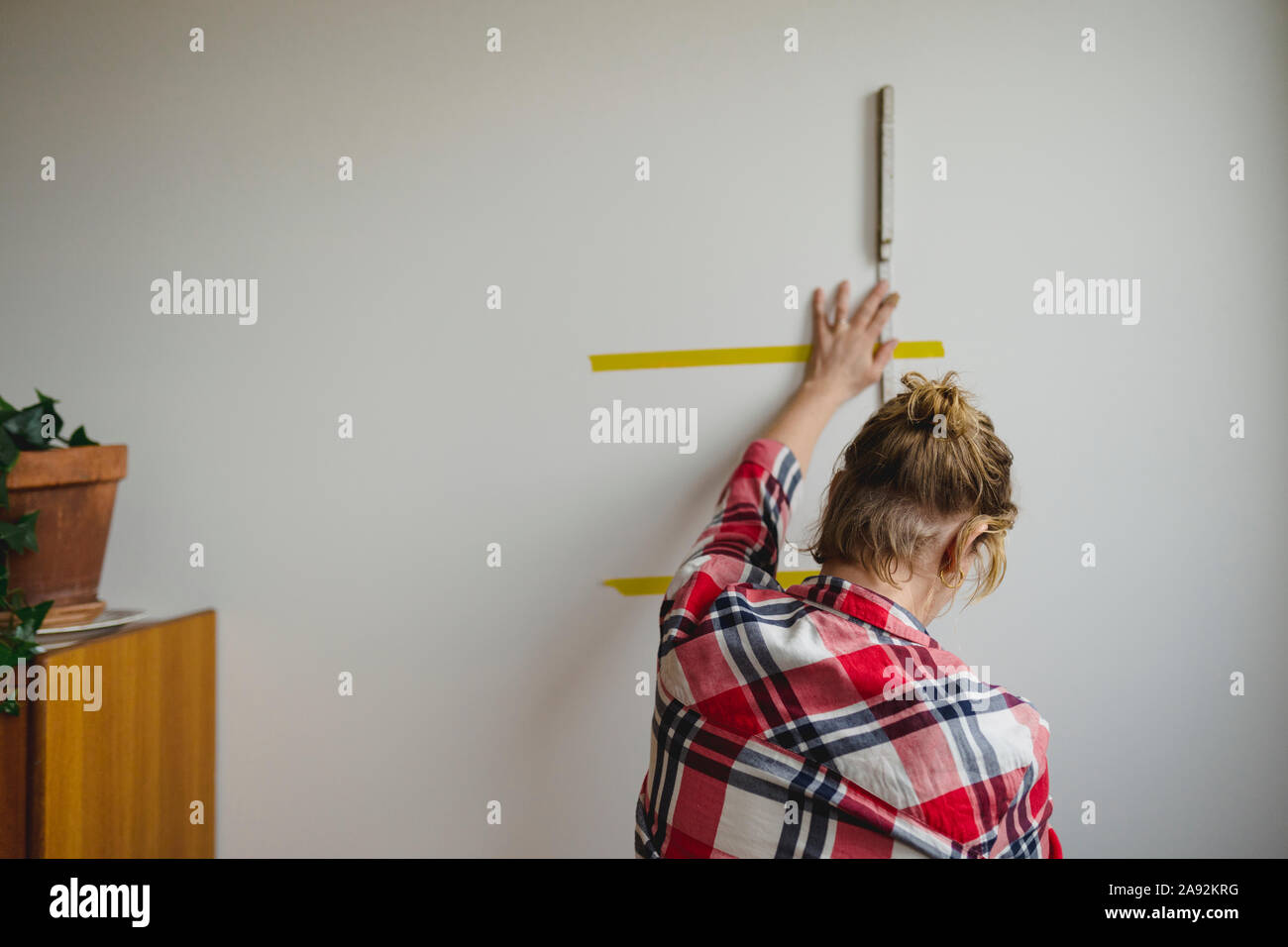 Woman leveling wall Stock Photo