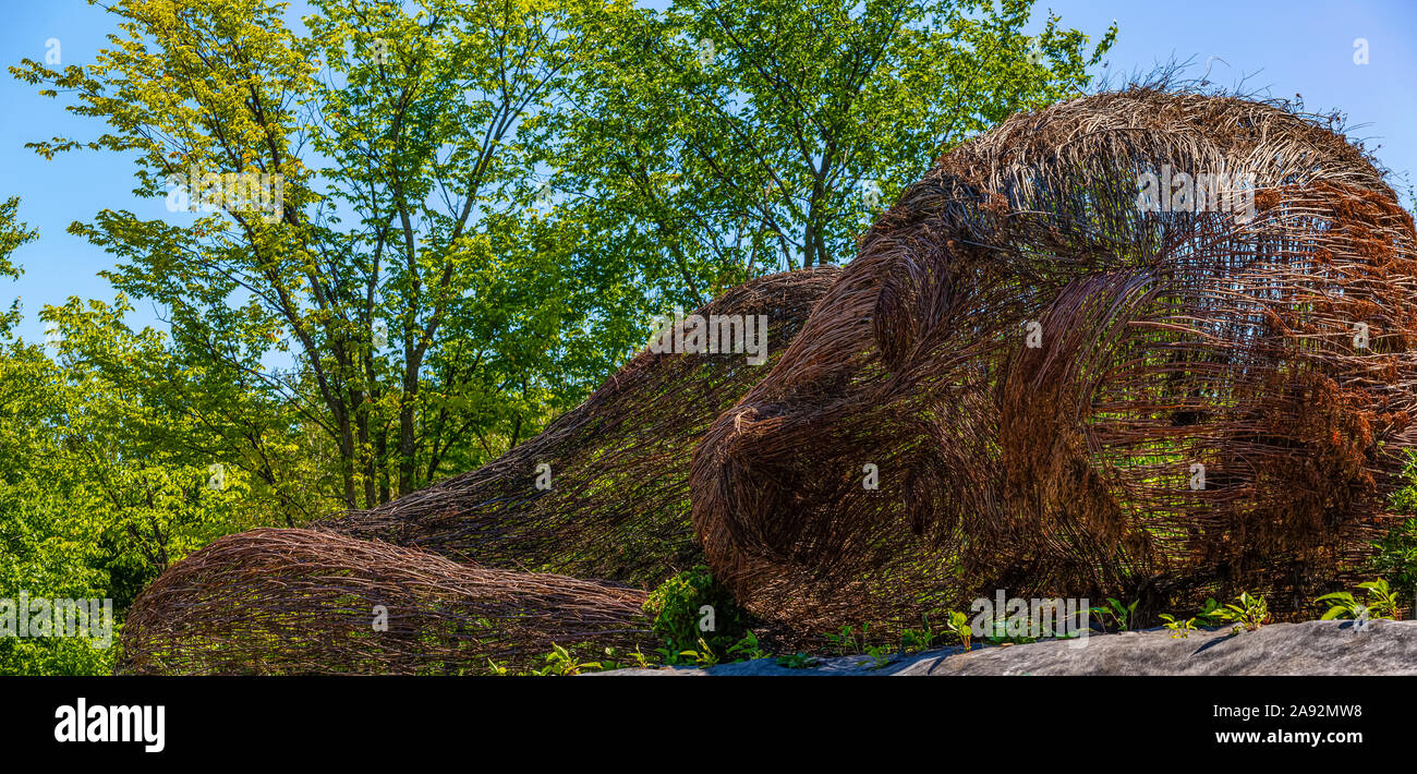 Frame of a brown topiary in the shape of a monkey lying on the ground; St Lazare, Quebec, Canada Stock Photo