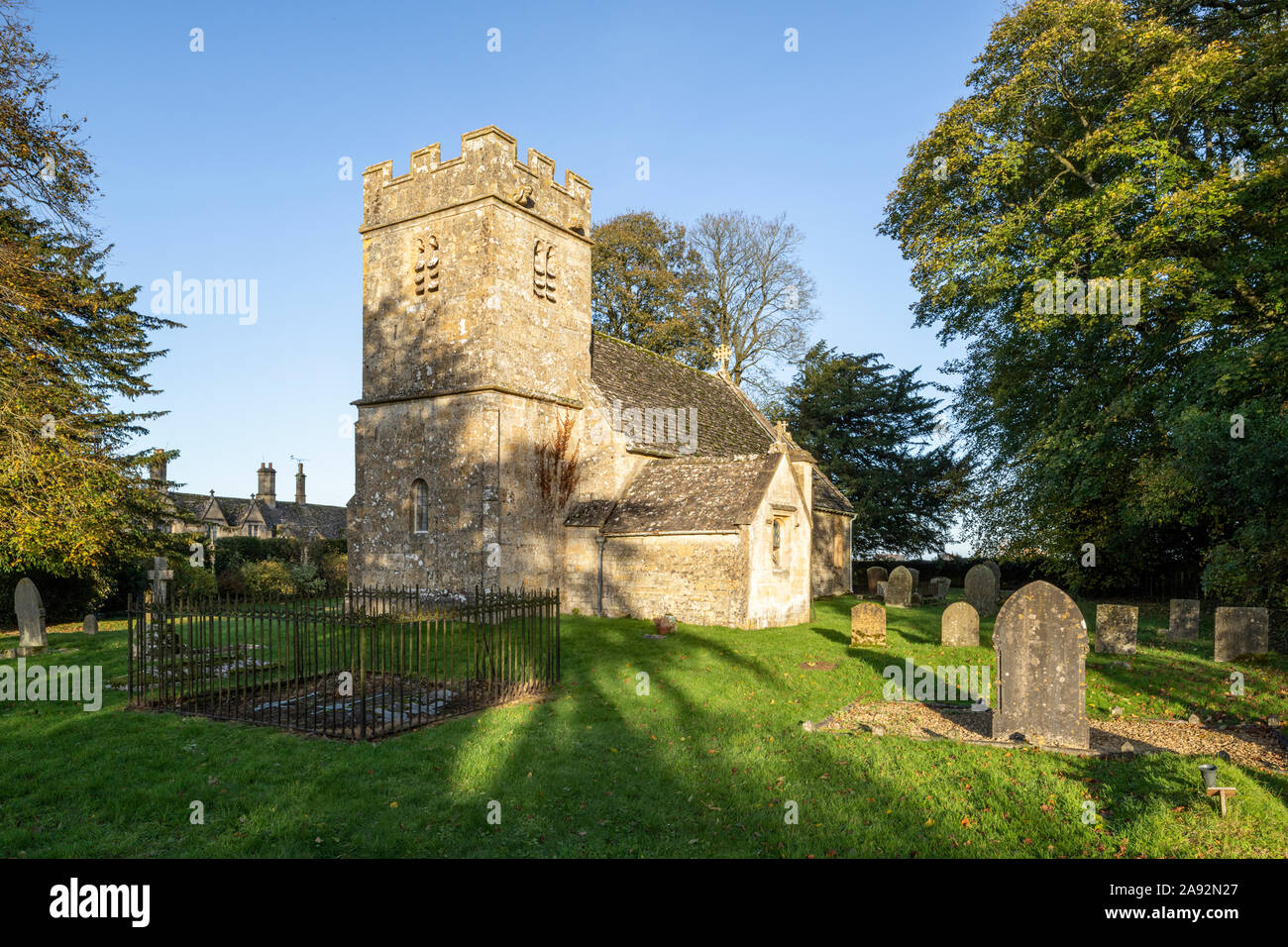 Small Norman All Saints church beside the Jacobean manor house in the grounds of Salperton Park in the Cotswold village of Salperton, Gloucestershire. Stock Photo