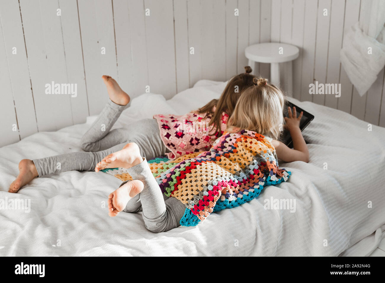Girls using digital tablet Stock Photo