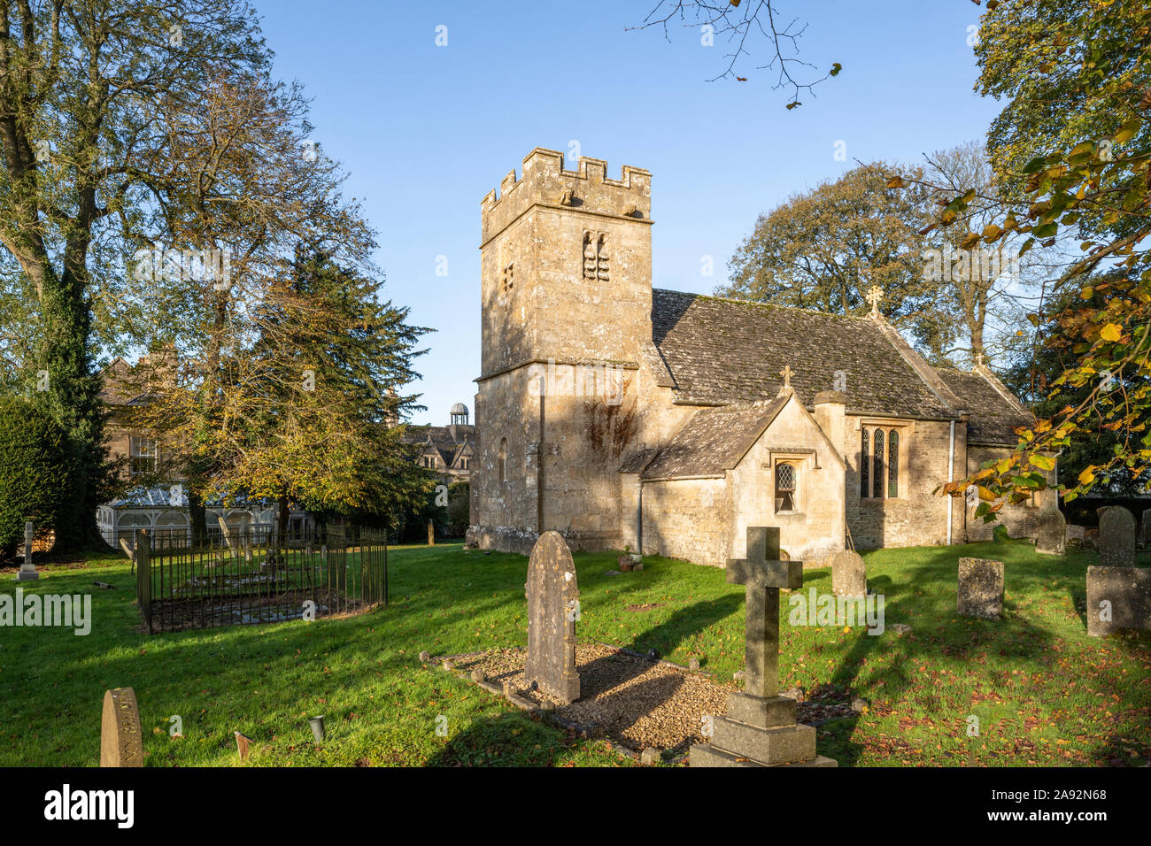 Small Norman All Saints church beside the Jacobean manor house in the grounds of Salperton Park in the Cotswold village of Salperton, Gloucestershire. Stock Photo