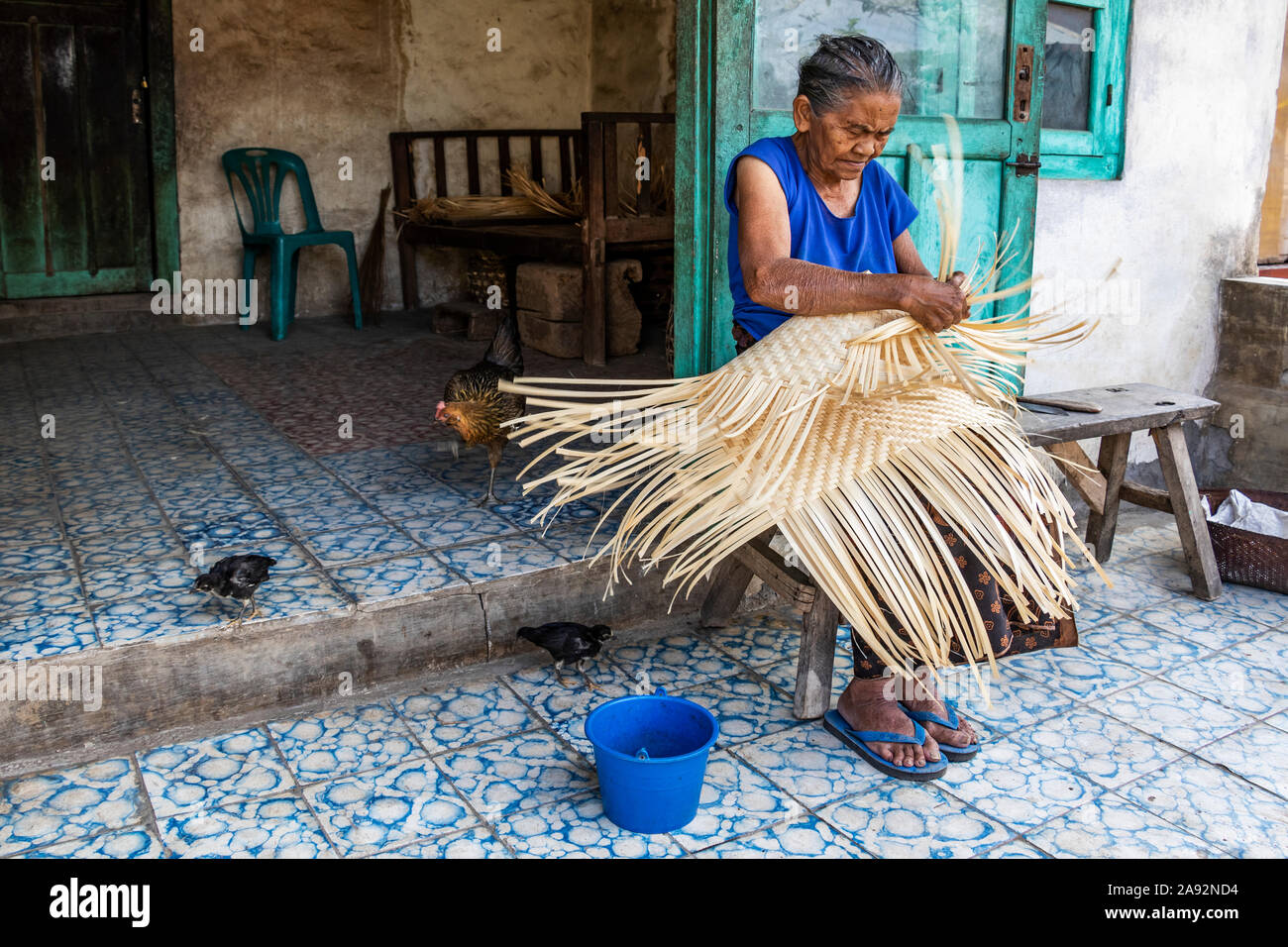 An elderly woman weaving a basket; Sidetapa, Bali, Indonesia Stock Photo