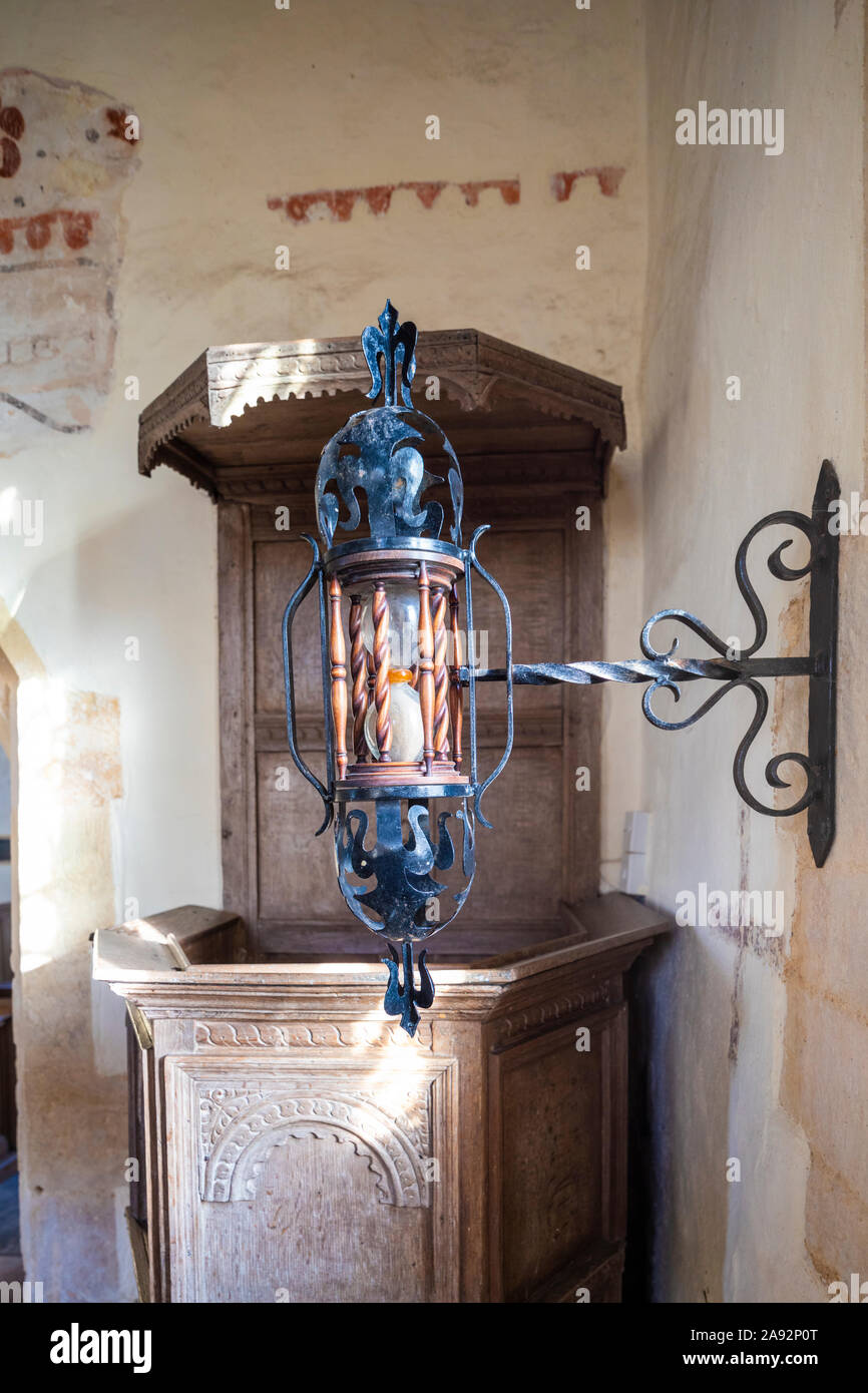 A wrought iron hourglass and 17th century pulpit in the 13th century church of St Mary in the Cotswold village of Shipton Solers, Gloucestershire UK Stock Photo