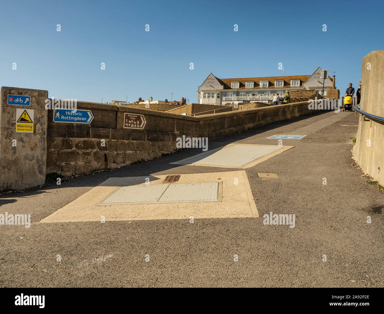 Signposts to Rottingdean Village seen from the beach promenade; Rottingdean, East Sussex, England Stock Photo