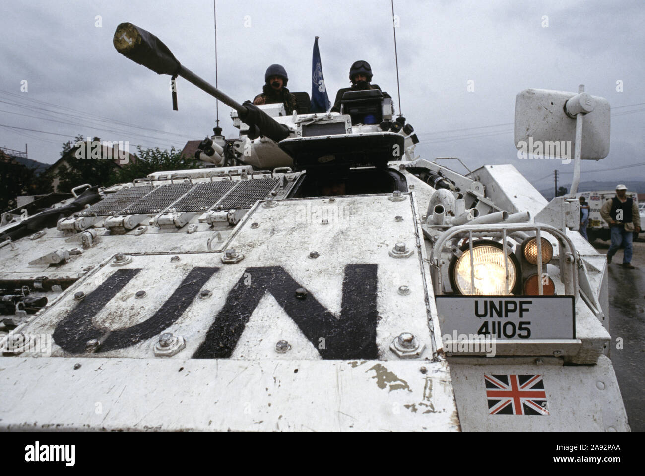 7th July 1993 During the war in Bosnia: a British Army Warrior MCV (Mechanised Combat Vehicle) of the Cheshire Regiment, headlights ablaze, on the main road outside the Press Information (P Info) house in Bila, near Vitez. Stock Photo