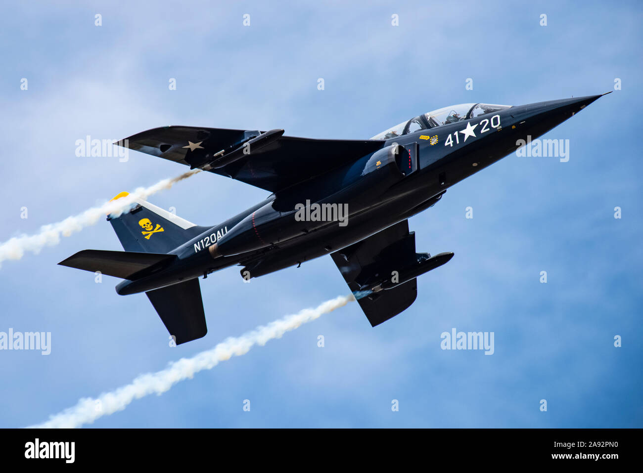 The 1981 DORNIER GMBH ALPHA-JET trailing smoke while performing aerobatic manoeuvres in the 2019 Olympic Air Show, Olympic Airport Stock Photo