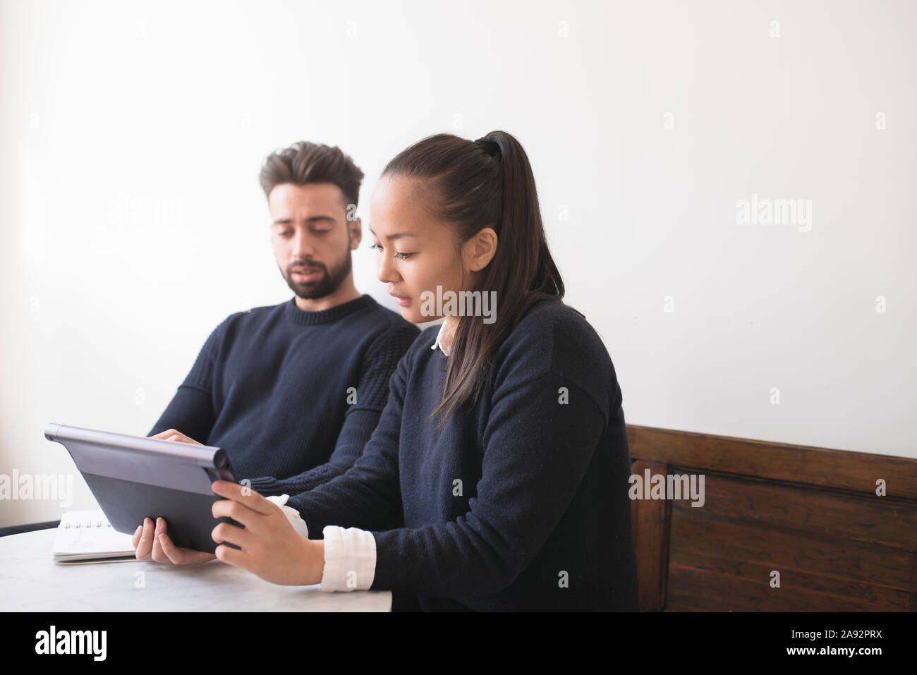Couple in cafe using digital tablet Stock Photo