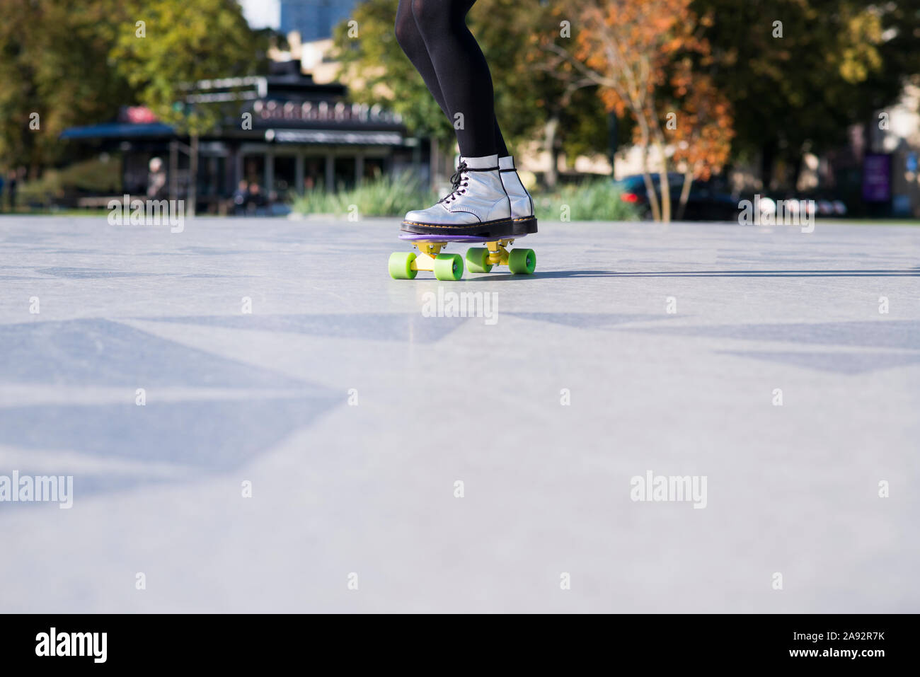 Woman skateboarding, low section Stock Photo