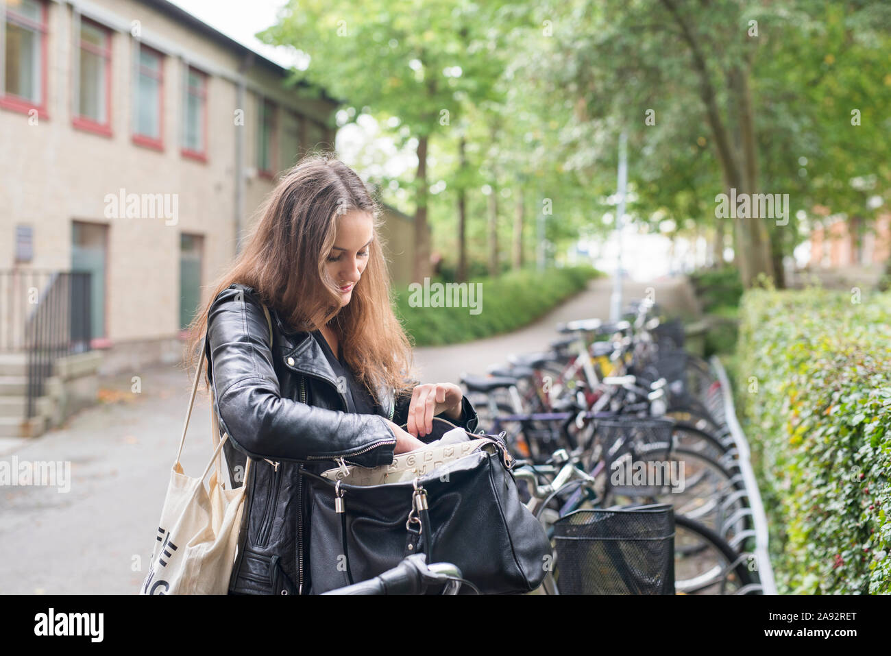 Young woman checking her bag Stock Photo