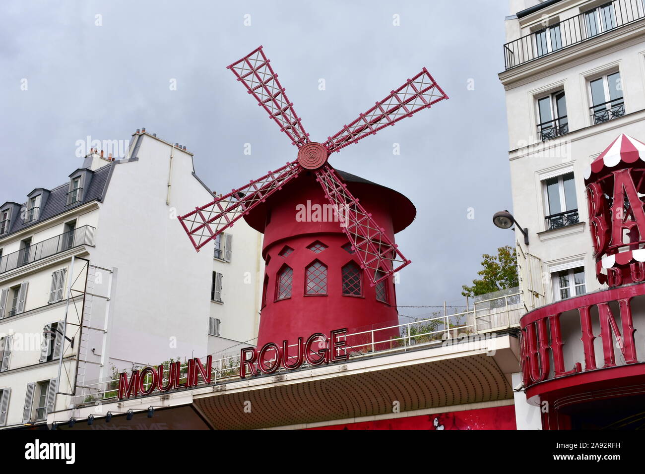 Famous Moulin Rouge cabaret located at Pigalle district close to Montmartre. Red windmill close-up. Paris, France. August 18, 2019. Stock Photo