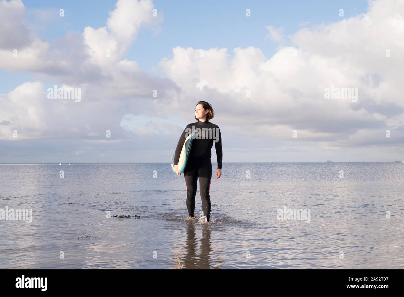 Female surfer with surfboard Stock Photo