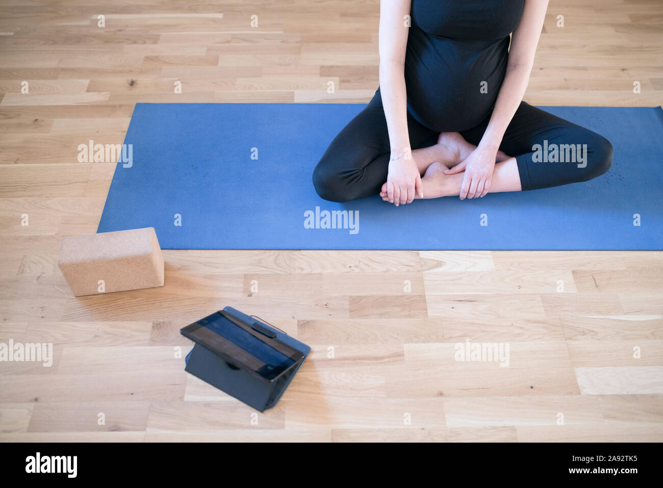 Pregnant woman practicing yoga Stock Photo