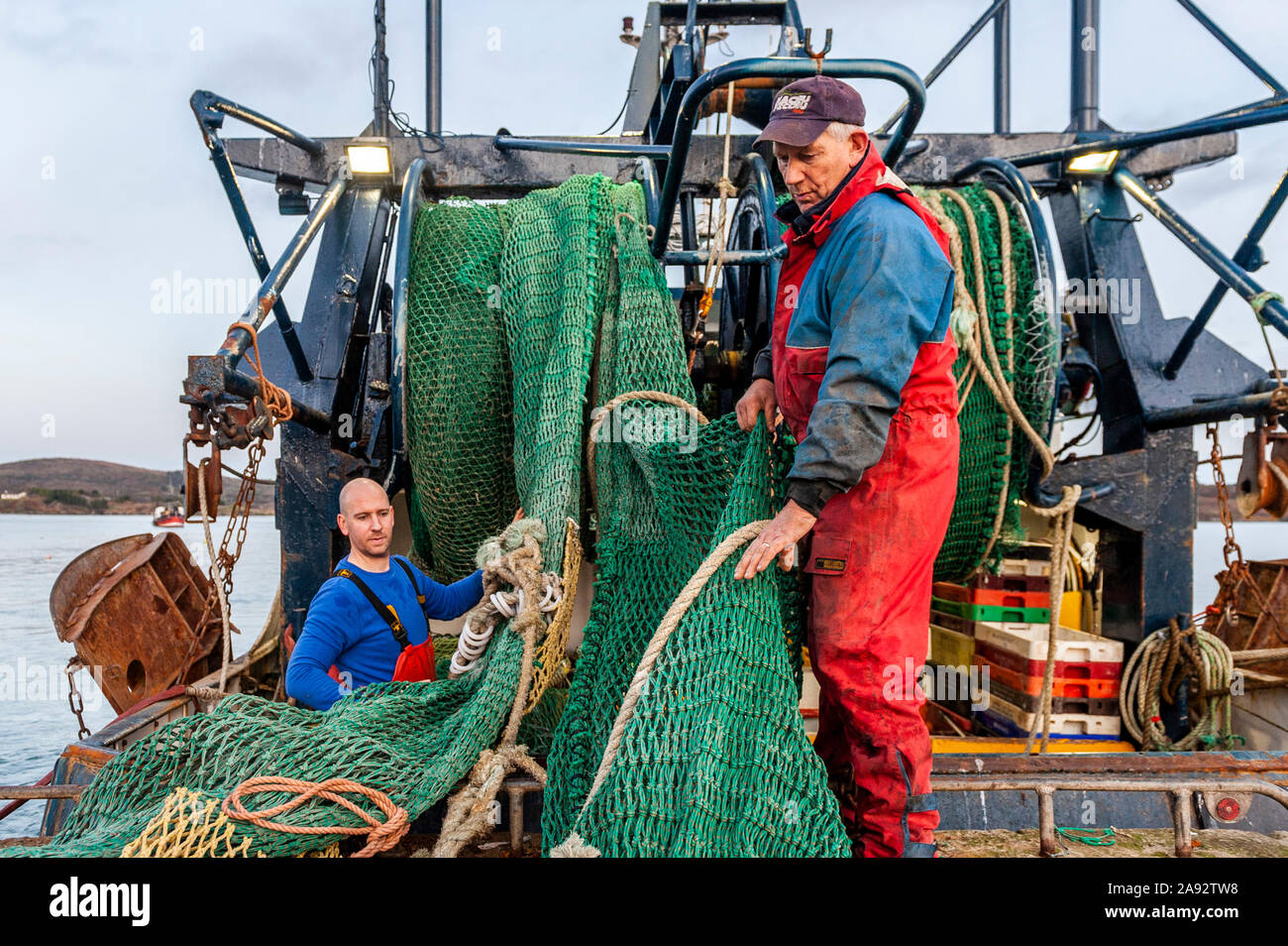 Schull, West Cork, Ireland. 12th Oct, 2019. Skipper of fishing trawler  'Laetitia', Thomas Sheehan, loads a new net onto his boat in preparation  for a fishing trip. This evening will be wet