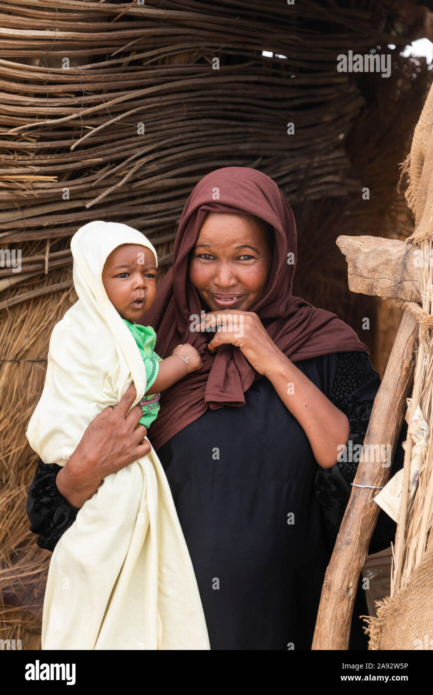 Sudanese woman holding a baby; Kokka, Northern State, Sudan Stock Photo