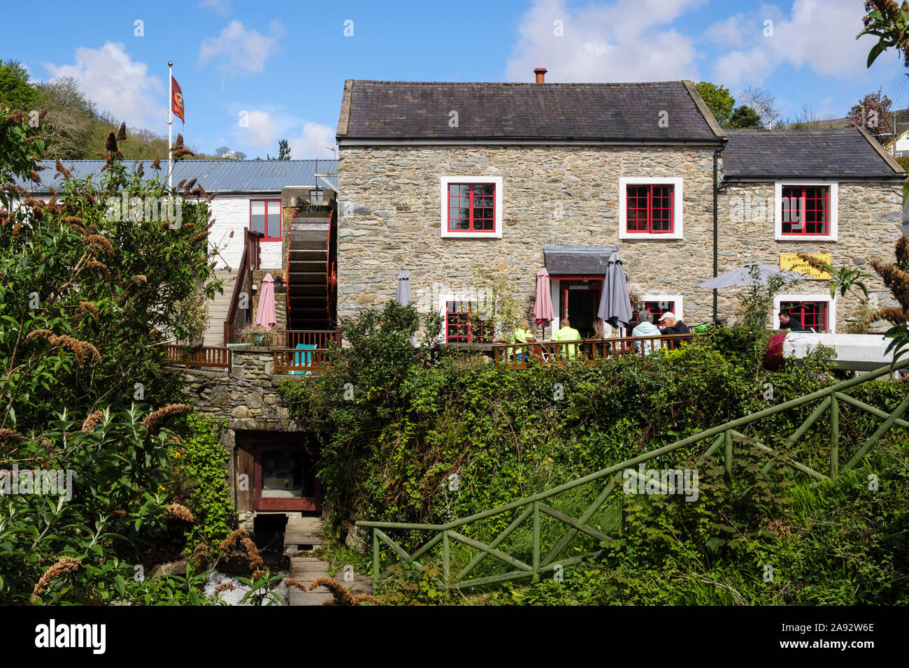 Ballacregga Corn Mill tearooms and cafe with waterwheel and people