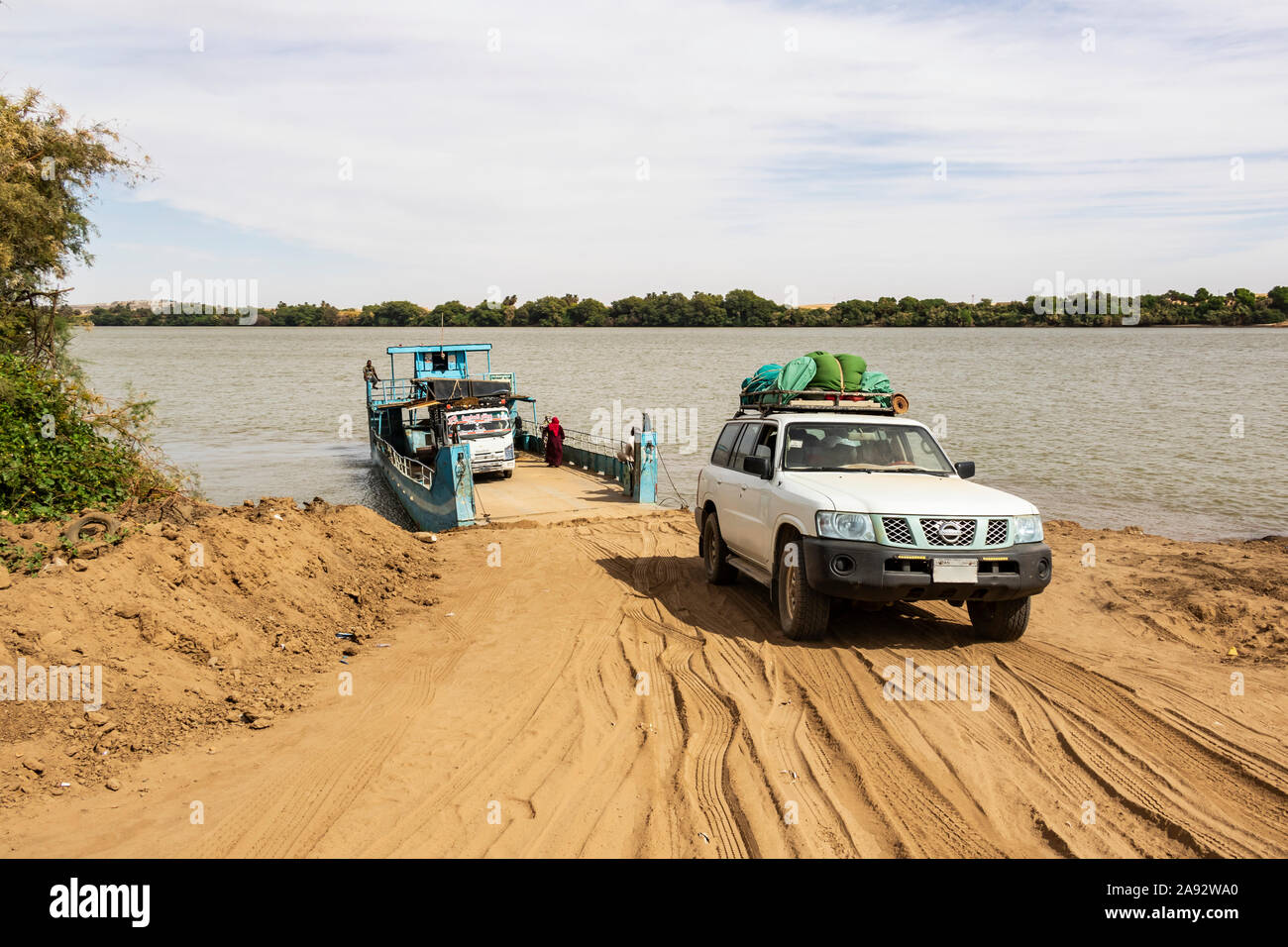 Four-wheel drive Toyota Land Cruiser exiting a ferry over the River Nile; Kokka, Northern State, Sudan Stock Photo
