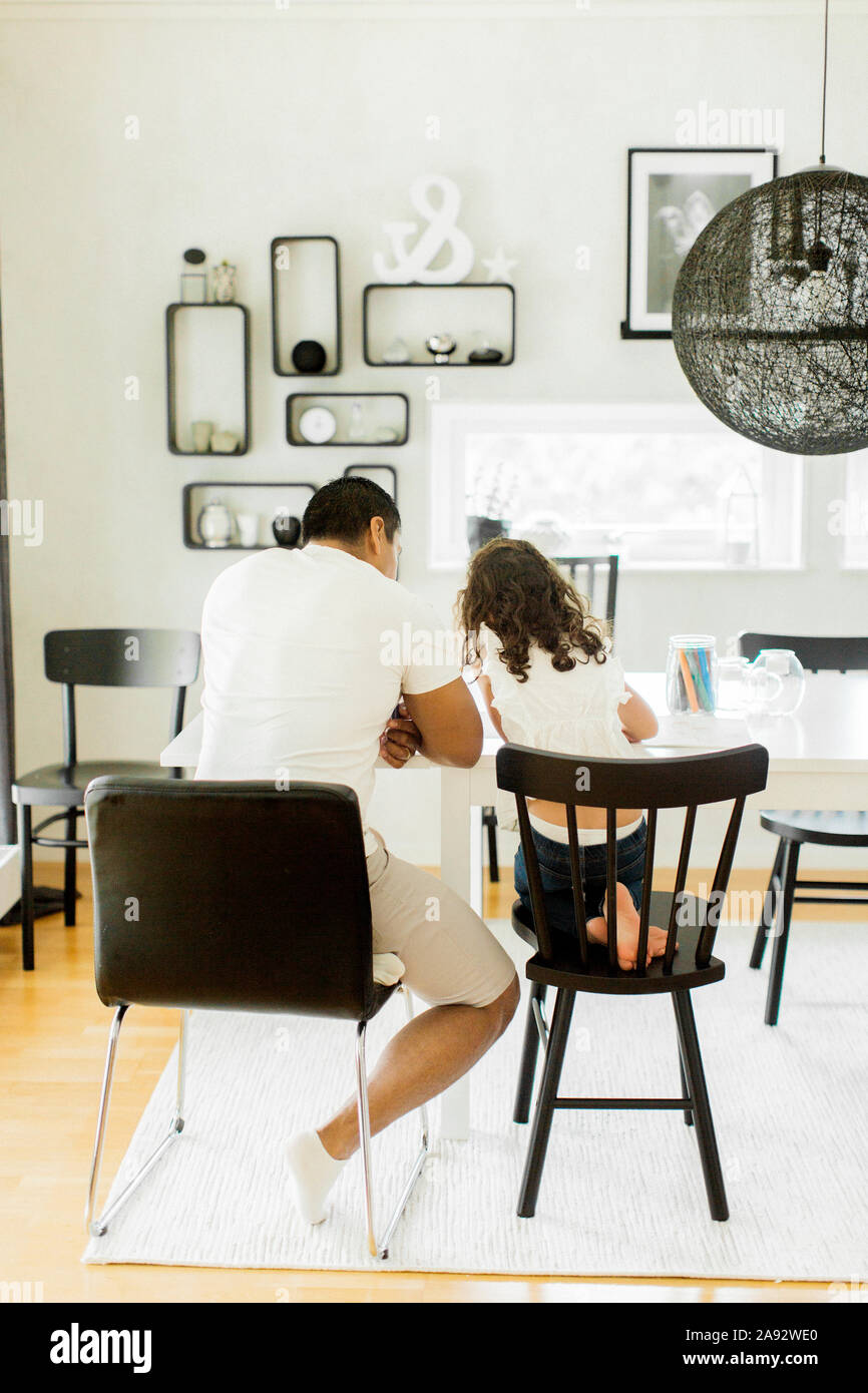 Father with daughter in living room Stock Photo