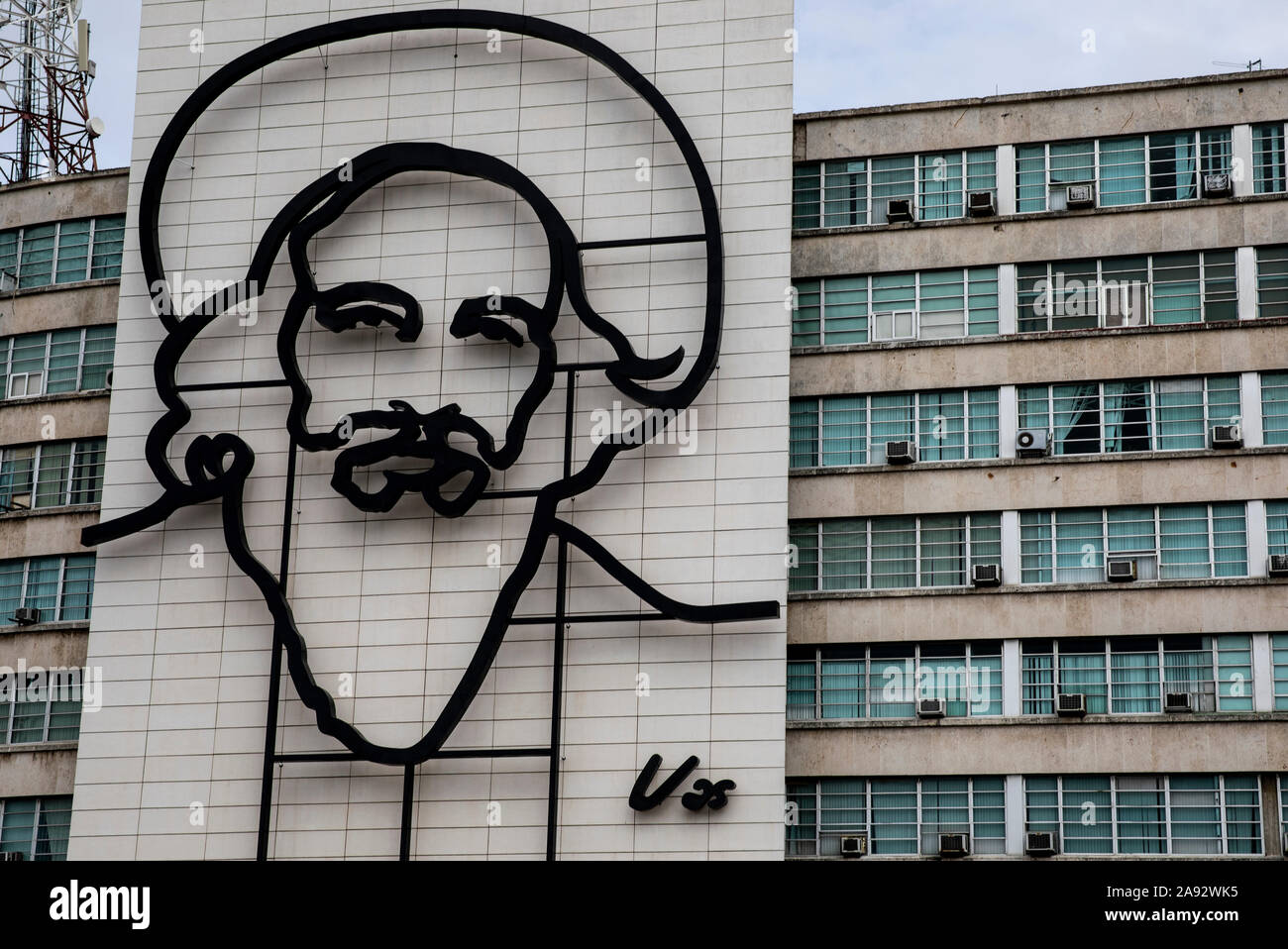 Art feature of revolutionary Emilio Cienfuegos on the side of a government building; Havana, Cuba Stock Photo