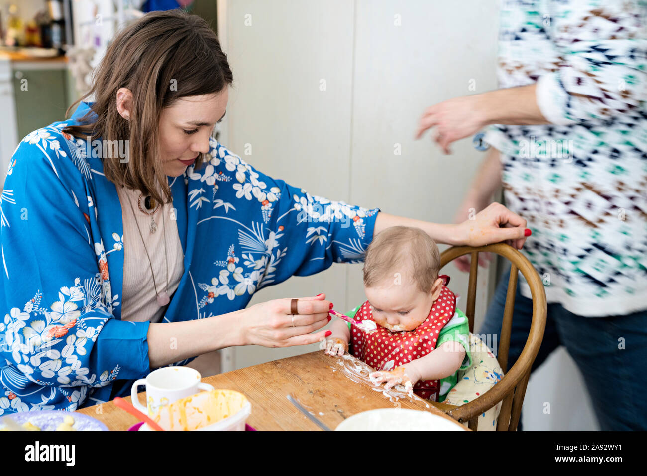 Mother feeding baby girl Stock Photo
