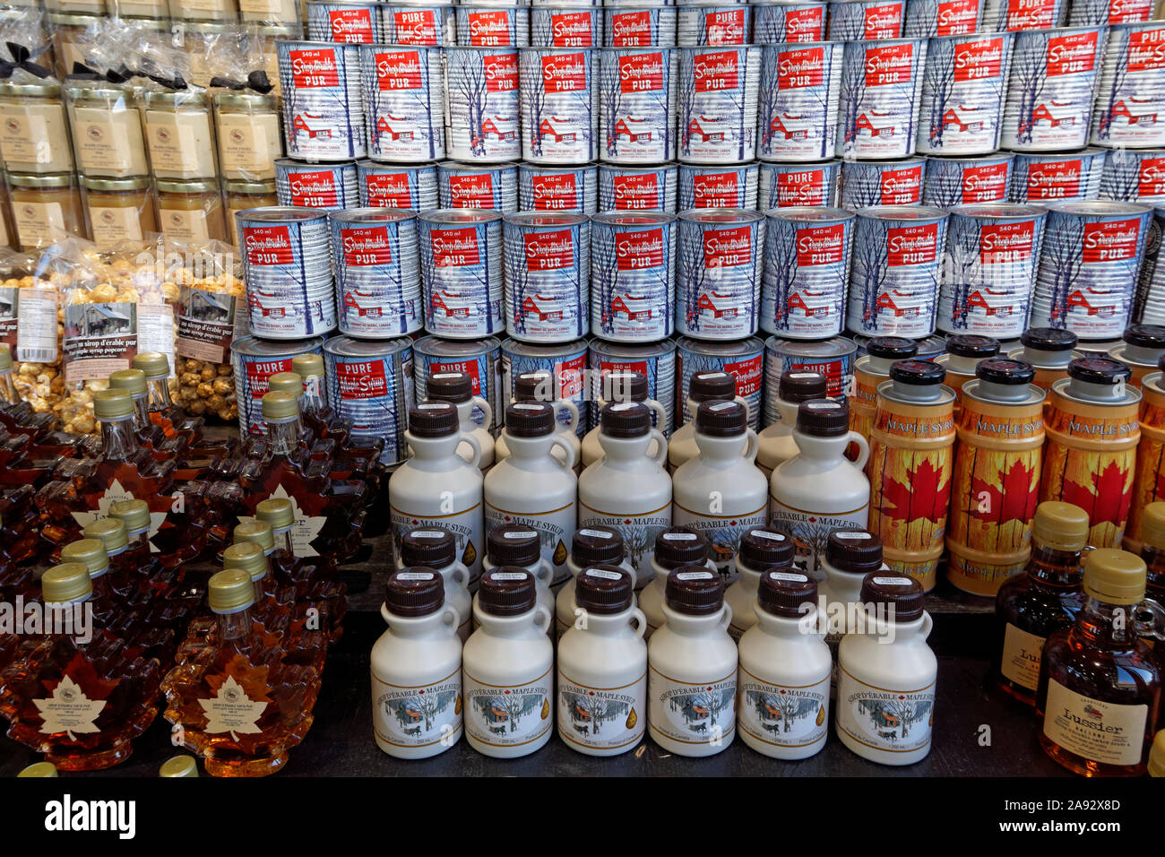 Tin cans and bottles of Quebec maple syrup products for sale at the Jean Talon Market, Montreal