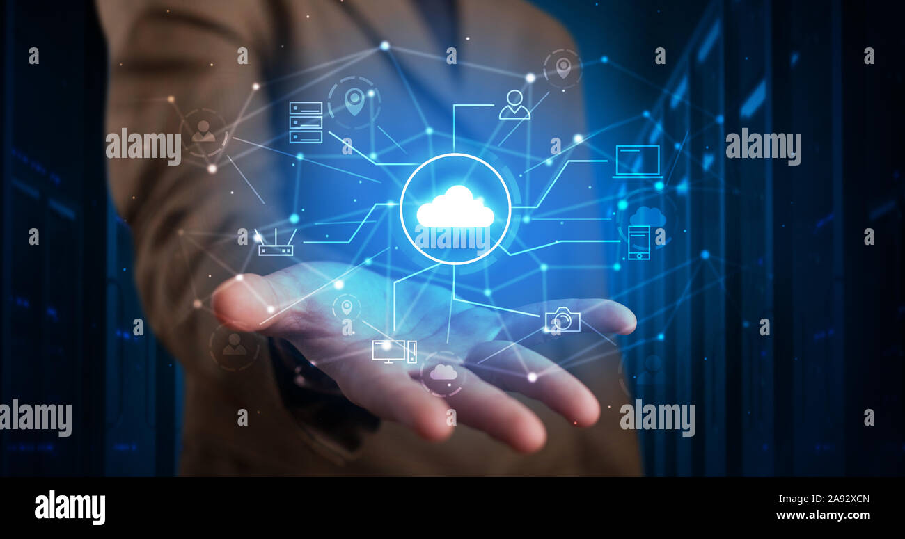 Man holding hologram projection displaying cloud technology symbols Stock Photo